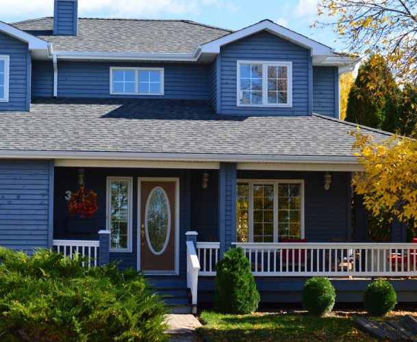 A two-story house with navy blue siding